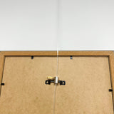 Artiteq Ophanghaak Rond Messing 5kg aan houten fotolijst